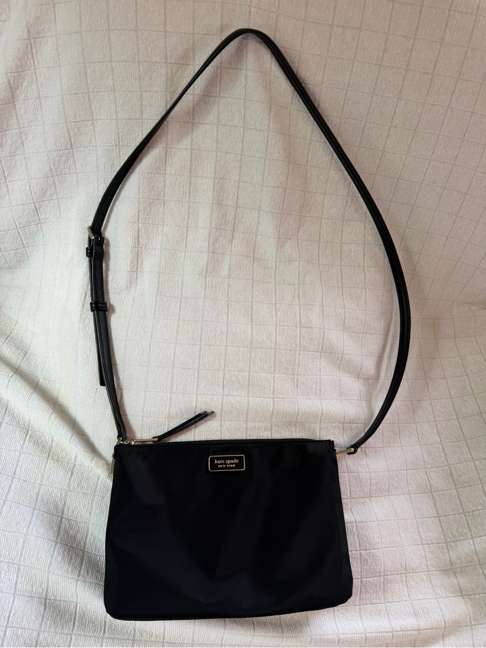 Kate Spade New York black nylon crossbody with gold accents